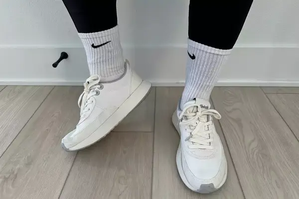 A person stands while wearing the Allbirds Women