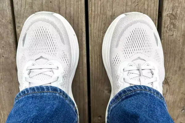 An overhead view of the Hoka Bondi 9 sneakers worn on wooden planks