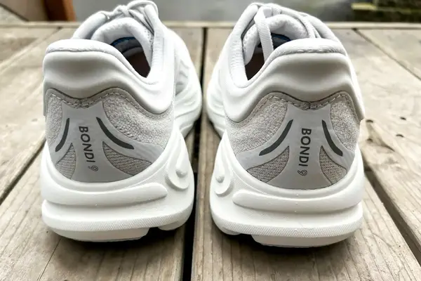 The back of the Hoka Bondi 9 shoes posed on wood