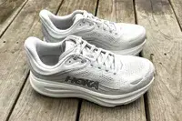 The side-view of the Hoka Bondi 9 shoes posed on wood