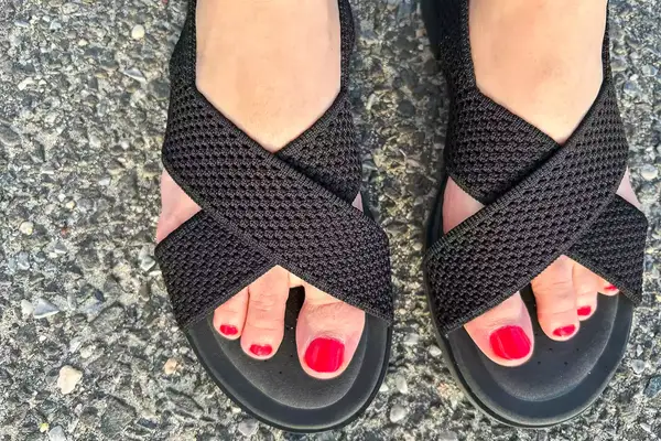 Close up of person wearing Vivaia Arch Pro AdaptAll Sandals (Pamela).