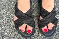 Close up of person wearing Vivaia Arch Pro AdaptAll Sandals (Pamela).