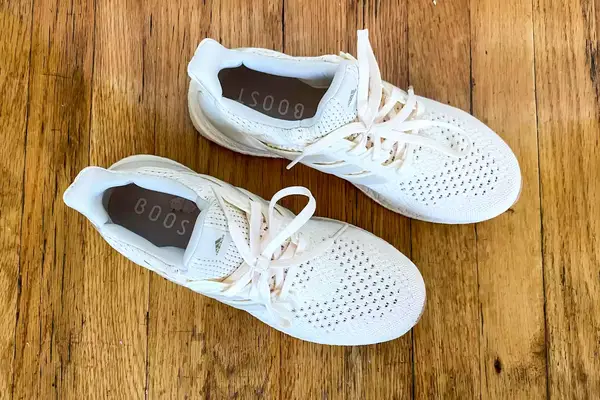 An overhead view of the Adidas Ultraboost 1.0 sneakers on a wooden floor