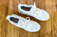 An overhead view of the Adidas Ultraboost 1.0 sneakers on a wooden floor