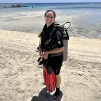 The OutdoorMaster Beach Umbrella with Sand Bag setup on the beach