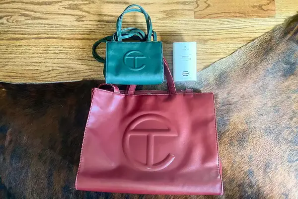 Kidde Carbon Monoxide Detector laid out next to two Telfar Bags