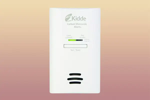 Kidde Carbon Monoxide Detector on a pink and yellow gradient background