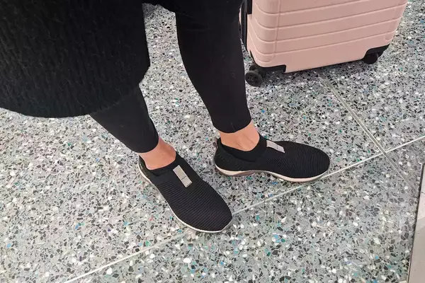 A person stands outside while wearing the Ryka Women