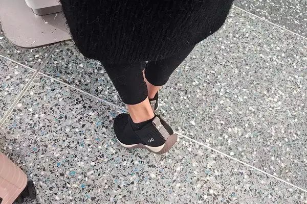 A person walks on stone while wearing the Ryka Women