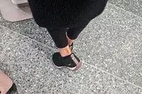 A person walks on stone while wearing the Ryka Women