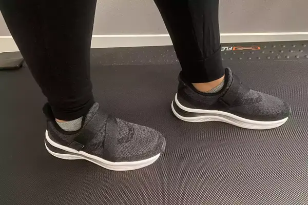 A person walks on a treadmill while wearing the Orthofeet Women