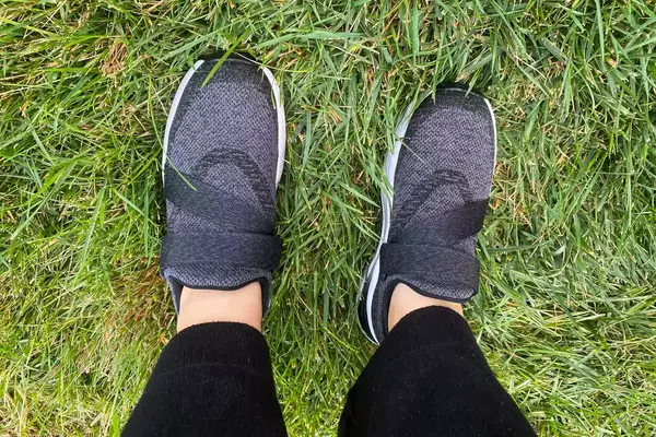 A person stands in grass while wearing the Orthofeet Women