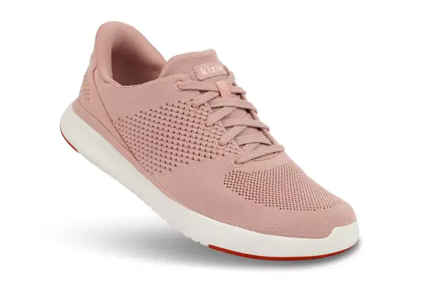 A person walks through grass while wearing the Orthofeet Women