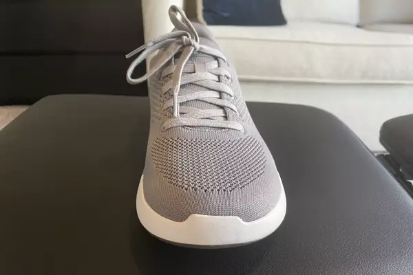 A person walks on a treadmill while wearing the Orthofeet Women