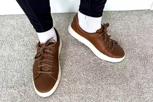 A person posed while wearing the Kizik Women’s Vegas Sneakers on carpet