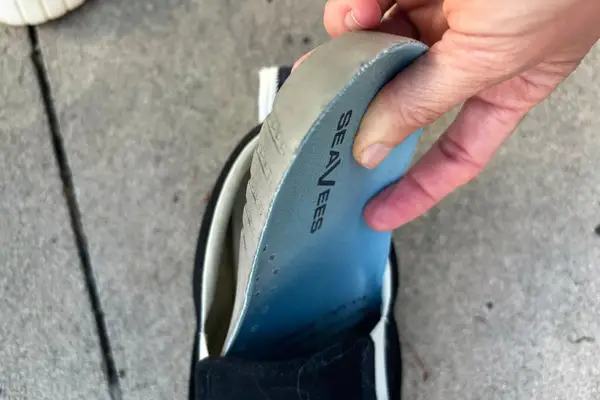 A person wearing OluKai Pehuea Slip On Sneakers.