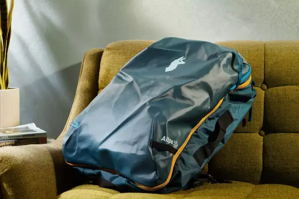 The side view of the EPICKA Universal Travel Adapter on a gray fabric background