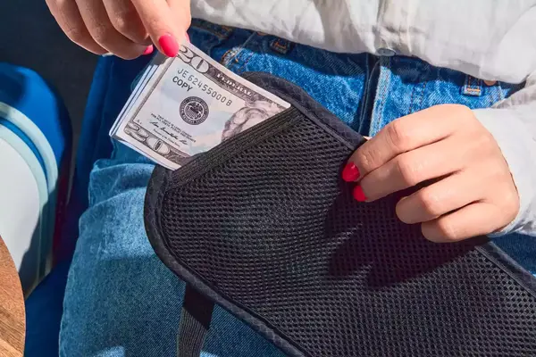 Person putting money inside the Molarun Travel Money Belt