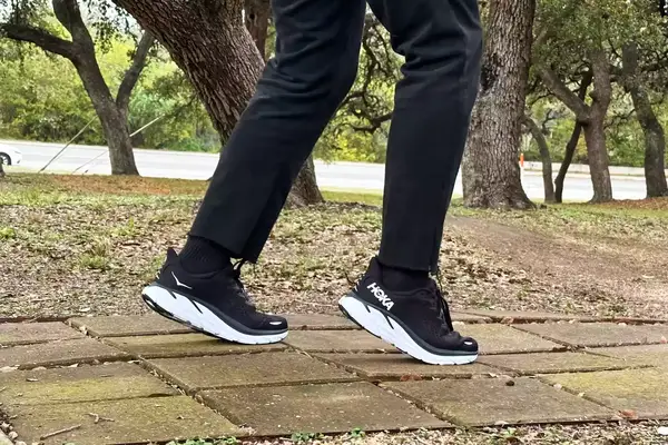 A wet Case-Mate Pelican Marine IP68 Waterproof Phone Pouch containing a phone on concrete near water