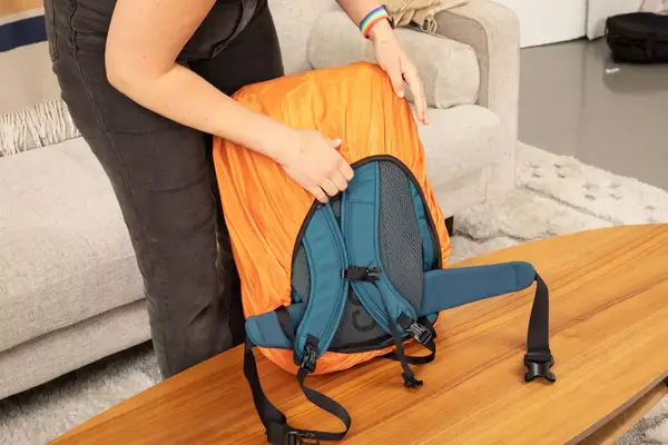 The EPICKA Universal Travel Adapter inside of its travel case on gray fabric