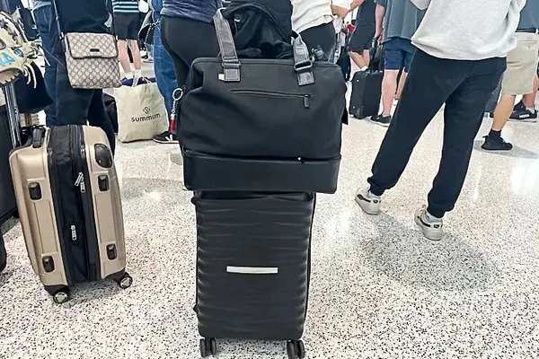 Béis Mini Weekender on top of a suitcase