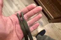 A hand holding the strings of the Nomatic Outset Jogger