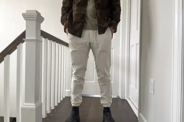 A person stands in a hallway while wearing the lululemon License to Train Jogger