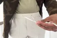 A person holds the waist strings on the lululemon License to Train Jogger