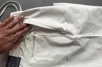 A person examines the zippered pocket on the lululemon License to Train Jogger