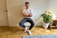 A person sits in a chair while wearing the Patagonia Men