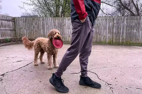 A person walks outside on concrete while wearing the Under Armour Men