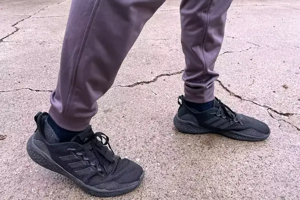 A person walks outside while wearing the Under Armour Men