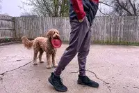 A person walks outside on concrete while wearing the Under Armour Men