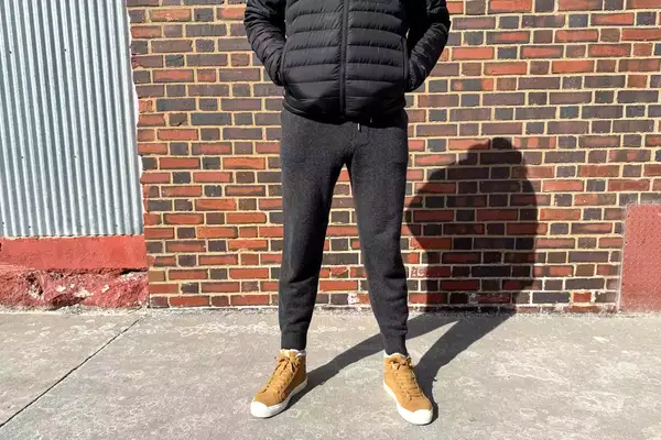 A person in front of a brick wall while wearing the Quince Mongolian Cashmere Jogger