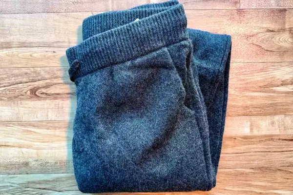 The Quince Mongolian Cashmere Jogger folded on a wooden surface