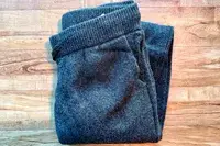 The Quince Mongolian Cashmere Jogger folded on a wooden surface