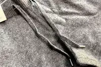 A close-up of two strings on the Quince Mongolian Cashmere Jogger