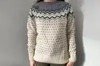 A person standing wearing the Fjallraven Ovik Knit Sweater