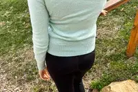 A person standing outside wearing the Naadam The Original Cashmere Sweater