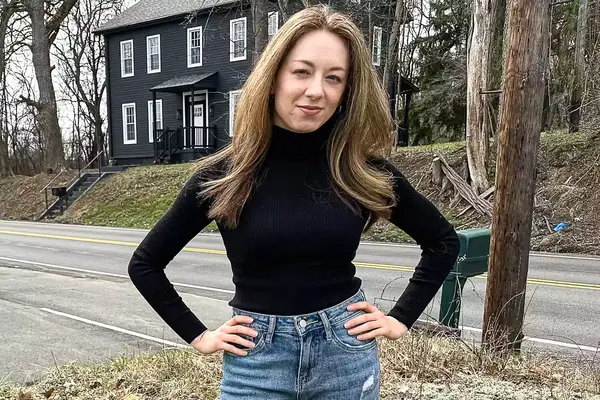 A person wearing the Uniqlo Merino Ribbed Sweater