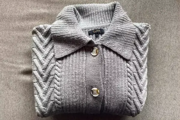 Quince Australian Merino Wool Collared Cable Cardigan on a grey surface
