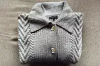 Quince Australian Merino Wool Collared Cable Cardigan on a grey surface
