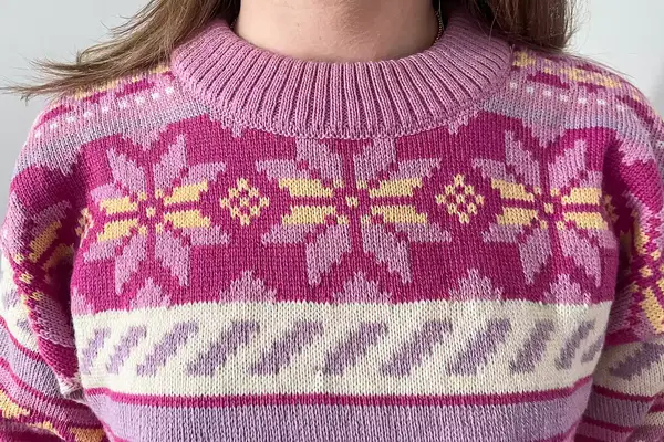 A close up of a person wearing the Dale of Norway Ingrid Sweater