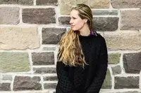 A person wearing the Aran Sweater Market Men