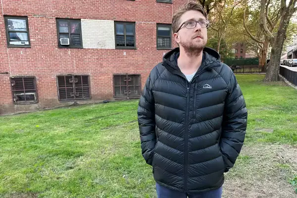 A person wearing the L.L. Bean Mens Ultralight 850 Down Hooded Jacket