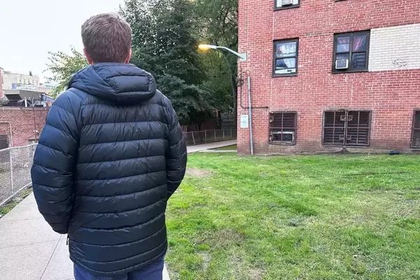 A person wearing the L.L. Bean Mens Ultralight 850 Down Hooded Jacket