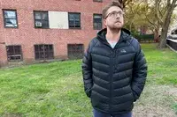 A person wearing the L.L. Bean Mens Ultralight 850 Down Hooded Jacket