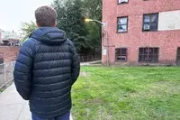A person wearing the L.L. Bean Mens Ultralight 850 Down Hooded Jacket