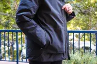 A person touches the fabric on the Cotopaxi Calidez Men