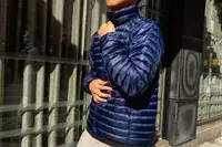 A person zips up the Marmot Men